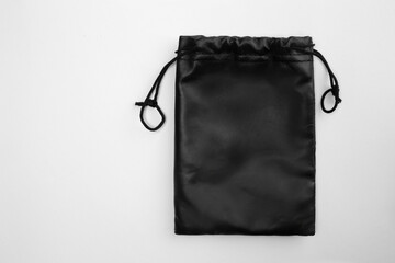 Black drawstring bag isolated on white background.