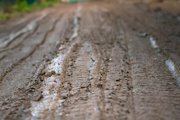 Mud on the road, dirt road in spring, rural dirt road after rains in spring,