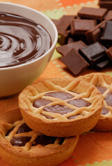 Chocolate cookies and chocolate cream and stack background.