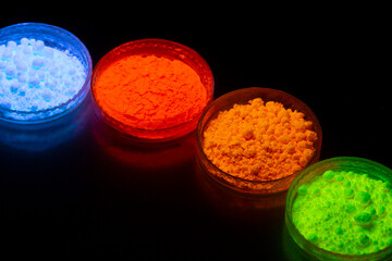 Fluorescent organic materials powder of red, yellow, green color for production OLED inside of glasses bottles in UV light.