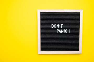 No panic test on a felt board on a yellow background. - obrazy, fototapety, plakaty