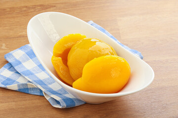 Sweet canned peaches with syrope