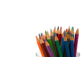 Fototapeta premium Variety of colored pencils in a glass isolated on white background and copy space. spot focus.