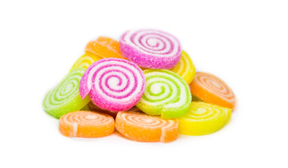 A sugar coated sweet tasting purple, green, orange and yellow gummy round isolated on a white background.