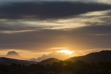Sunrise over the mountains, silhouette of the mountains, sky, clouds. Santa Ponca, Mallorca, Spain.	
