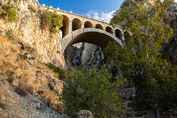 Train bridge of El Chorro in desfiladero de los gaitanes in Malaga, Spain. - obrazy, fototapety, plakaty