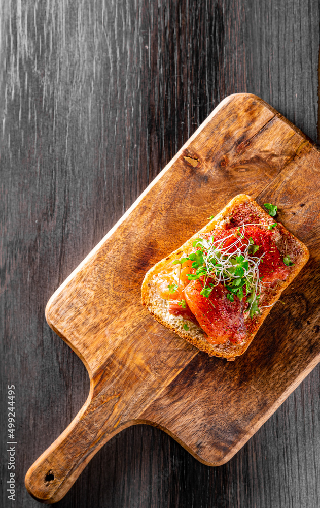 Wall mural bruschetta with salmon and cream cheese on wooden plate