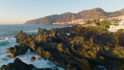 Naklejka na ściany i meble Volcanic pool in Los Gigantes, Tenerife. Rocky island in the Atlantic ocean.