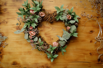 Heart shaped DIY flower wreath. DIY decoration for Valentines day or spring home decor.