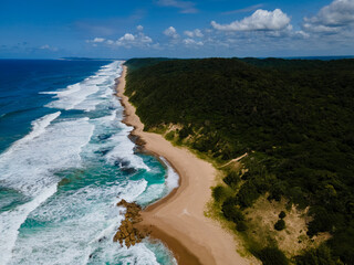 St Lucia South Africa, Rocks sand ocean, and blue coastal skyline at Mission Rocks beach near Cape...