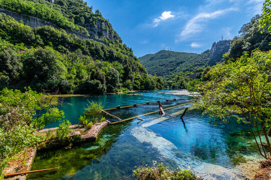 The Roman port of ancient Narnia in Stifone, in the canyons of the Nera river. The blue sky and the clear, cold and turquoise water, on a sunny day in the summer.