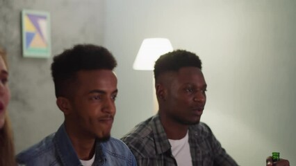 Black guys with tense friends watch play of favorite baseball team in living room slow motion. Enjoying interesting sports event at home. Racial diversity - Powered by Adobe