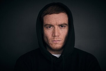 portrait of attractive middle aged red hair man in a black hoodie. strong man portrait. freckles face, melasma skin