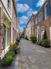 streetview of the city of Haarlem with old houses and a bicycle on a sunny day