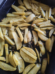 baked potatoes on a baking sheet in spices