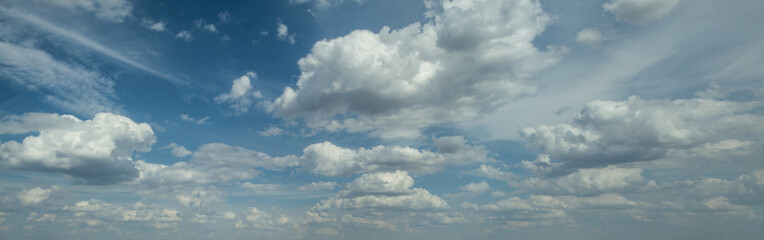 Panoramic blue background with sky and white clouds