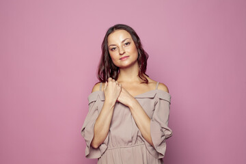 Beautiful smiling woman with clean skin, natural make up on pink background