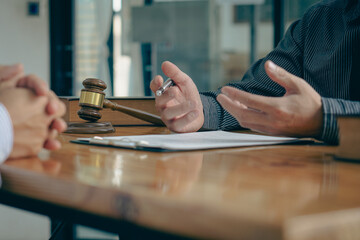 Businessmen seek advice from lawyers for good service cooperation. Judges with team meetings with clients Legal concepts and hammer and scales of injustice contract documents in the office
