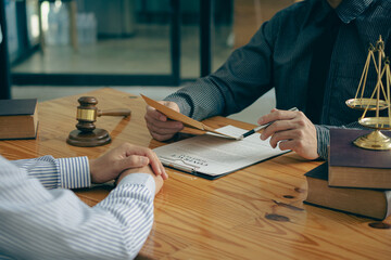 Businessmen seek advice from lawyers for good service cooperation. Judges with team meetings with clients Legal concepts and hammer and scales of injustice contract documents in the office