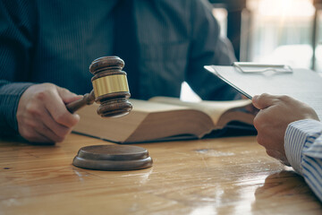 Businessmen seek advice from lawyers for good service cooperation. Judges with team meetings with clients Legal concepts and hammer and scales of injustice contract documents in the office