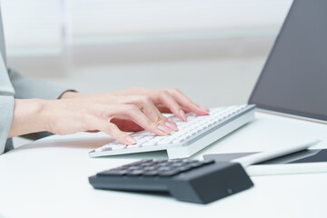 Fototapeta na wymiar A woman's hand hitting a computer keyboard