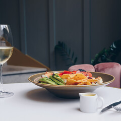 Lunch with healthy salad and glass of wine.
