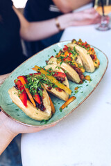 Waiter serving bao bans in a restaurant