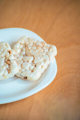 healthy food, loaves, small loads of bread on the white plate on the wooden background