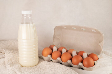 dairy products bottle of milk and eggs on the table and white towel