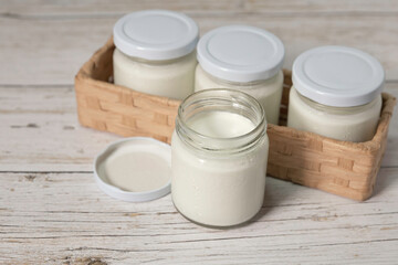 Obraz na płótnie Canvas fresh natural homemade organic yogurt in glass bottle on wooden table.