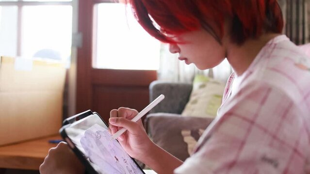 NFT artwork concept, Red hair artist girl using digital pen drawing a sketch on digital tablet, top view