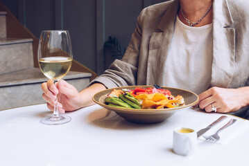 Close up of woman hands while she enjoying her lunch in cafe.