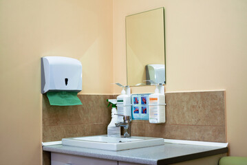 Washbasin with antiseptics and disposable paper towels