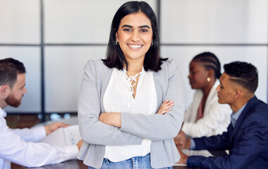 Unafraid and goal bound. Shot of a young businesswoman in the middle of a meeting.