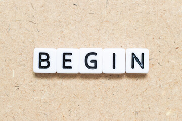 Obraz premium White tile alphabet letter with word begin on wood background