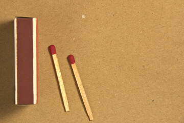 Matches and a pack of matches on a craft background. Place for text. background.