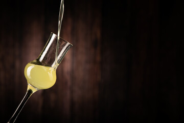Limoncello Sicilian liqueur is poured into a glass