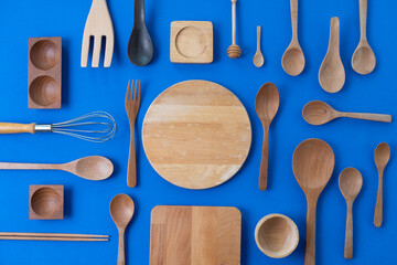 kitchen utensils wooden for cooking on the blue table, food prepare concept