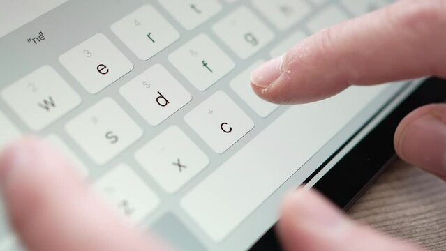 Closeup Fingers Typing on a Digital Keyboard on a Touch Screen