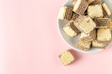 chocolate mini wafers on a pink background