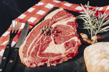 Raw beef meat on a dark wooden board.