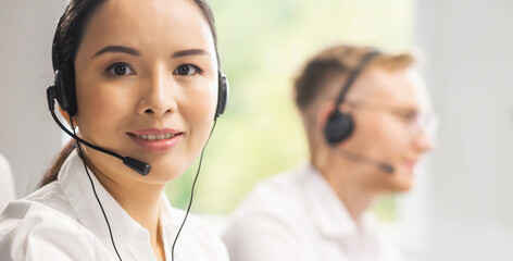 Team of professional support staff working in the office. Colleagues in the workplace solve customer problems. Call center and customer support concept.