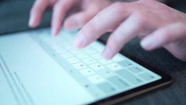Typing a Text on a Virtual Keyboard of a Tablet Touch Screen Closeup