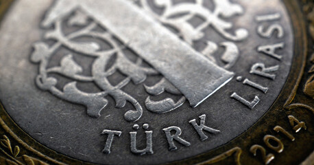 Translation: Turkish lira. Fragment of Turkish 1 lira coin closeup. National currency of Turkey. Illustration for news about economy or finance. Horizontal stories. Macro