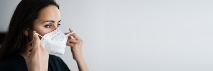 Woman Putting On Medical Face Mask