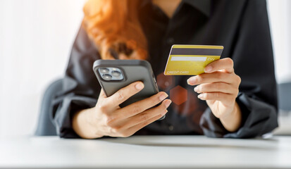 Women holding credit card and using smartphones at home.Online shopping, internet banking, store online, payment, spending money, e-commerce payment at the store, credit card, concept