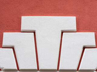 Detail of an abstract architectural pattern on the red facade of an old building