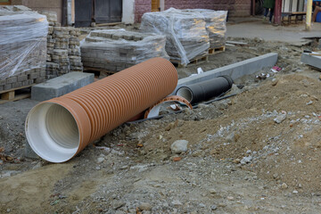 Pipe awaiting installation for laying the road reconstruction by repairing utilities the supplying...