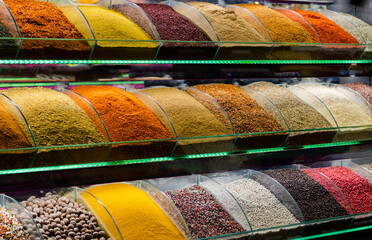 Raws of colorful spices on the wall, separated spices.