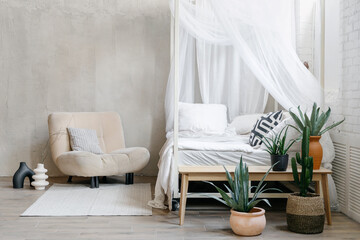 Light bedroom interior in bohemian chic apartment